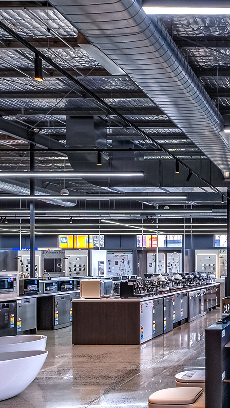 Havit Black Track Lights and Cylinder Pendants in a Large Commercial Showroom