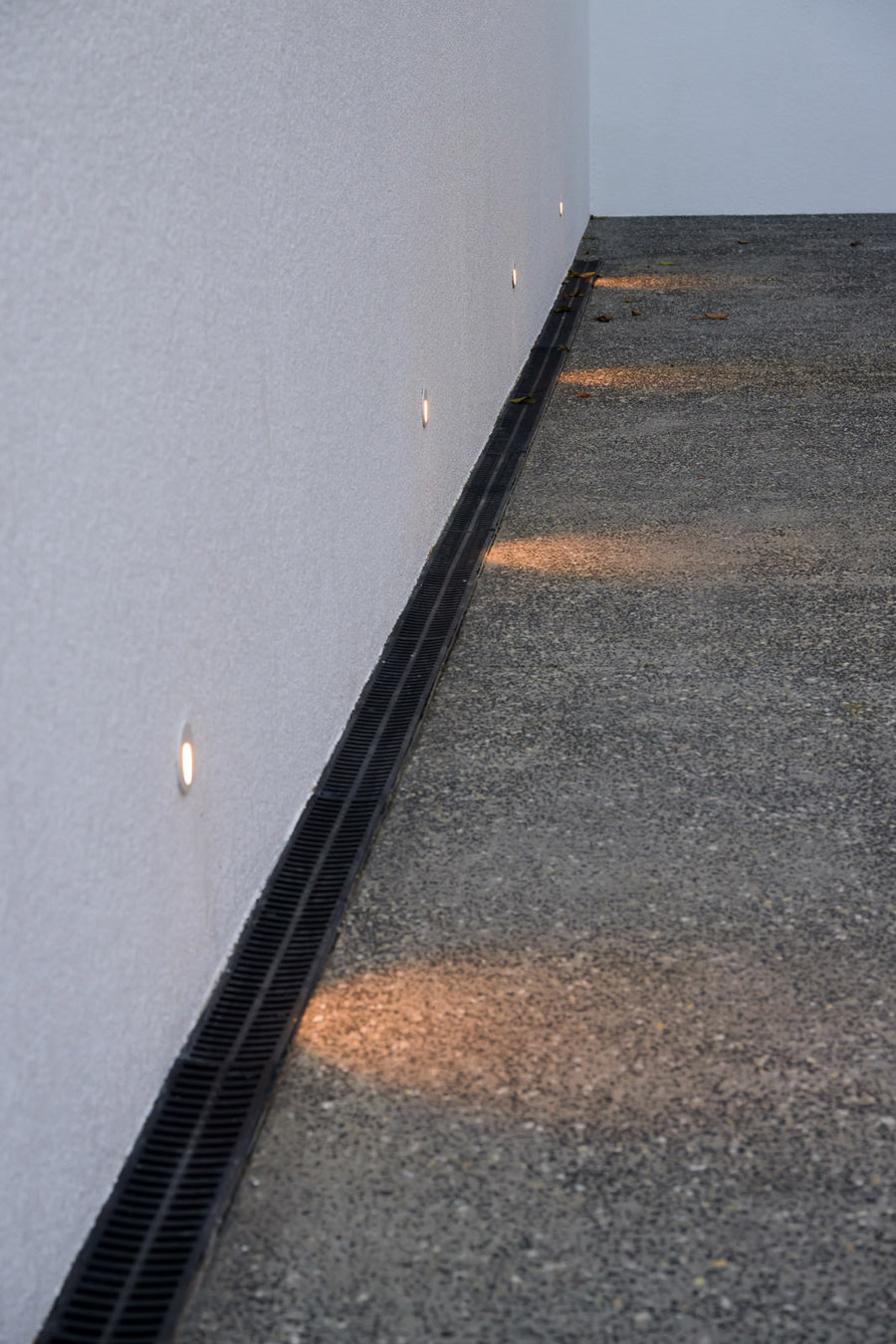 Havit Recessed LED Step Lights Mounted Along a White Rendered Exterior Wall