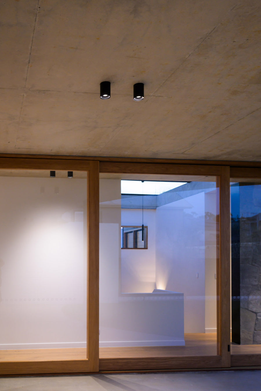 Havit Nella Black Surface Downlights on an Exposed Concrete Ceiling