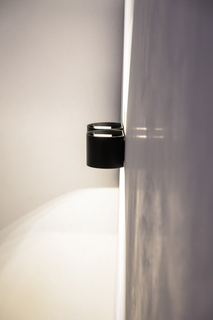 Havit Versa Black Round Wall Lights Paired on a Corner Wall
