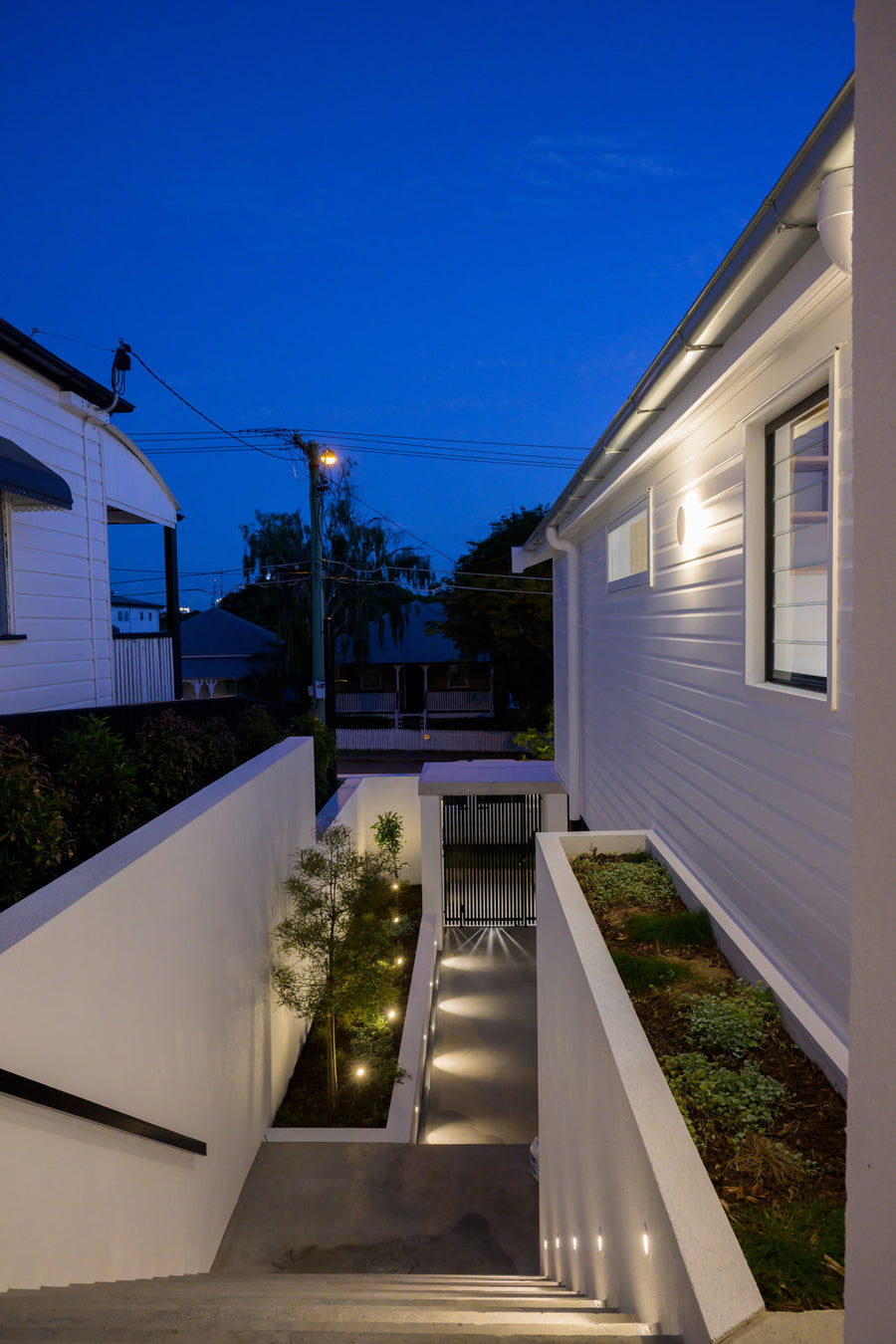 Havit Halo Wall Light, Step Lights and Spike Lights on a Home Exterior at Dusk