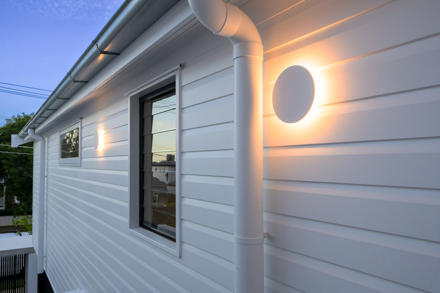 Havit Halo White Round Wall Lights on a White Weatherboard Home Exterior