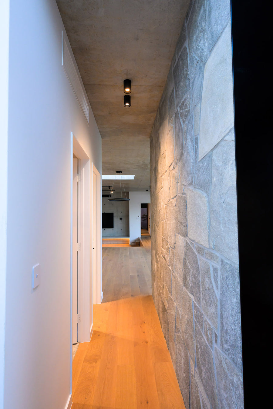 Havit Nella Black Downlights in a Stone and Concrete Hallway