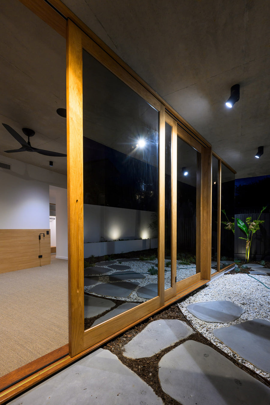 Havit Nella Adjustable Downlights Lighting an Indoor Outdoor Courtyard at Night
