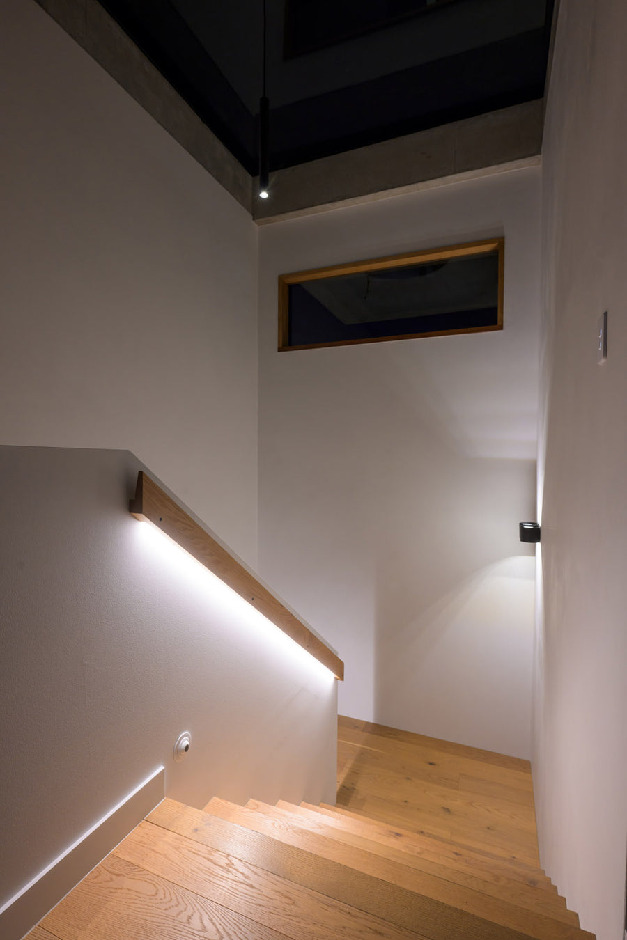 Havit LED Strip Under Handrail and Wall Lights on an Indoor Timber Staircase