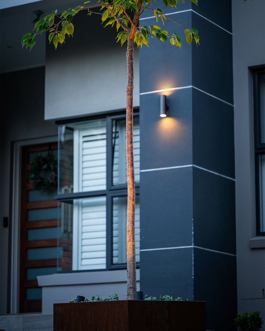 Black Up Down Wall Light & Garden Spike Lights on Modern Home Facade