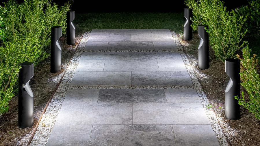 Black Round Bollard Lights Illuminating Garden Pathway