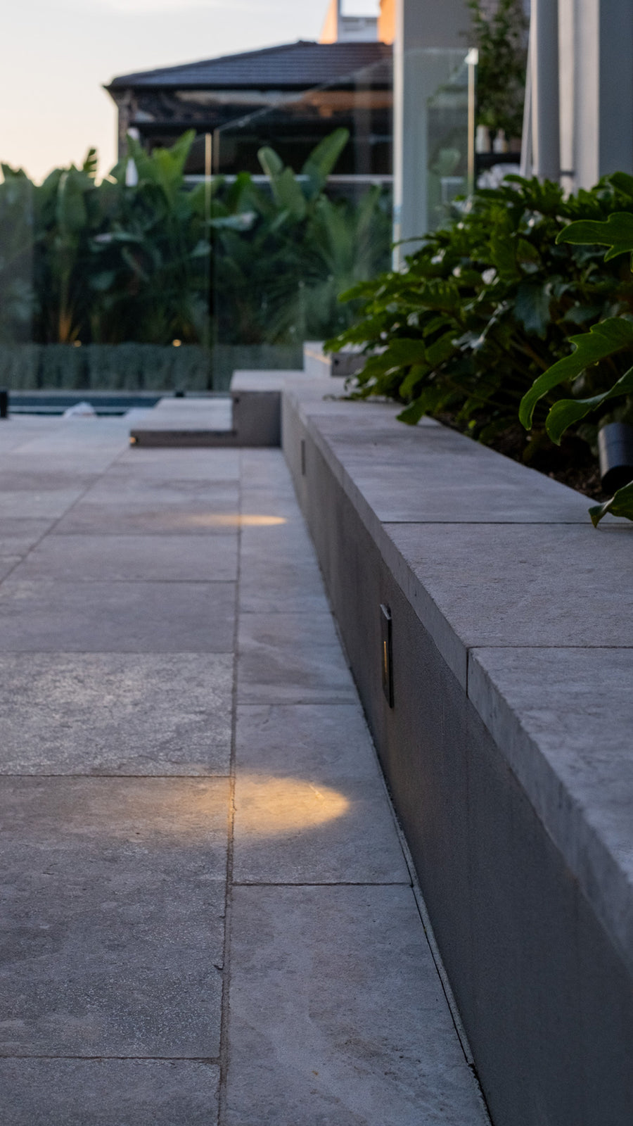 Mini Reces Black Step Lights Along Outdoor Patio Wall