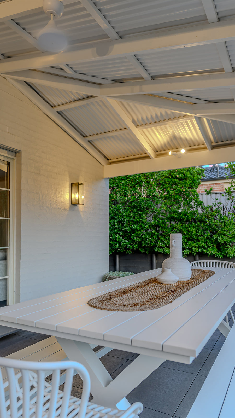 Bayside Large Black Wall Light and Tivah White Double Adjustable Spot Lights in Covered Patio