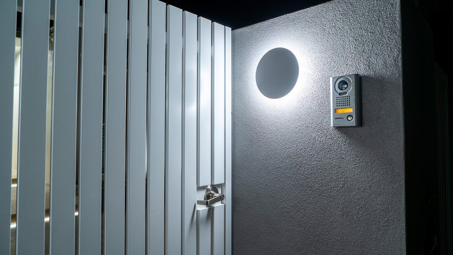 Havit Halo White Round Wall Light Mounted at a Residential Front Entry Gate