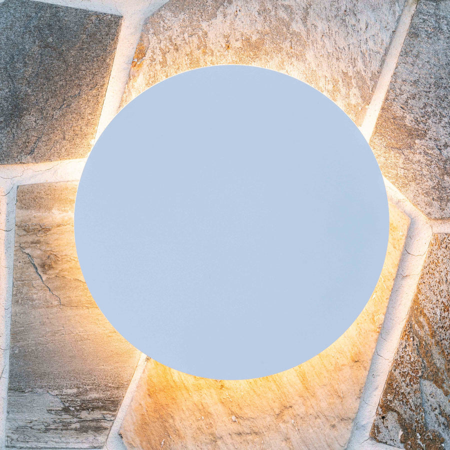 Havit Halo White Round Wall Light Close Up Glowing on a Natural Stone Wall