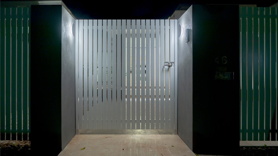 Havit Halo White Round Wall Lights Flanking a Residential Front Gate at Night