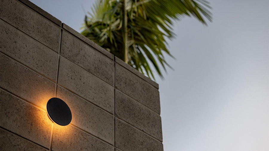 Havit Halo Black Round Outdoor Wall Light Mounted on a Concrete Block Wall