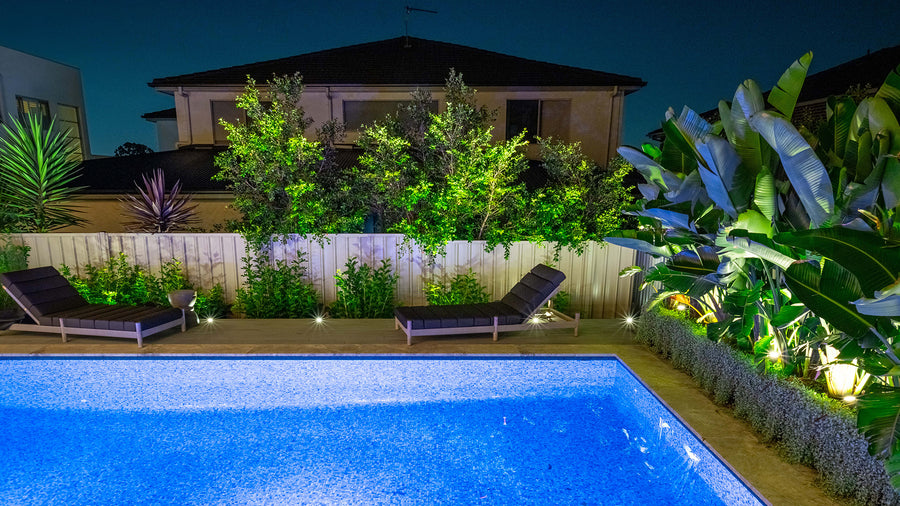 Havit Garden Spike Lights and Elite Inground Deck Lights Around a Residential Pool at Night