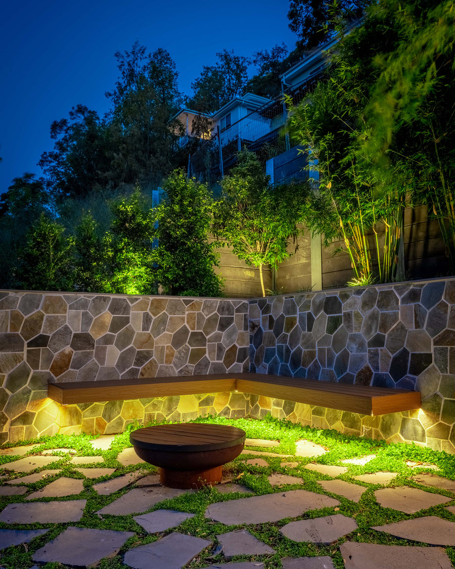 Havit Outdoor LED Strip Under a Stone Bench Seat in a Backyard Garden at Night