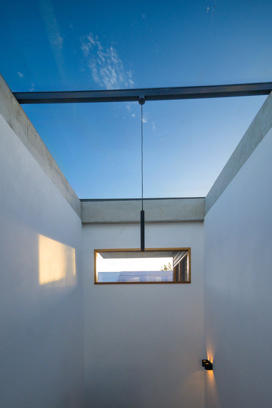 Havit Henger Black Cylinder Pendant and Versa Wall Light Under a Skylight