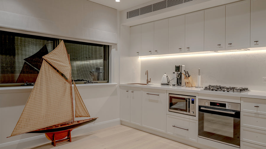 LED Strip Lighting Above Kitchen Bench in White Coastal Kitchen