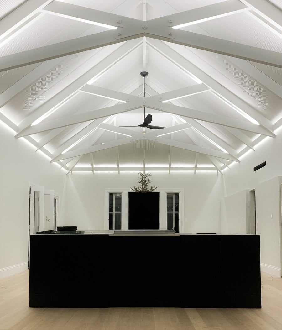 LED Strip Lighting Along Vaulted Living Room Ceiling Beams