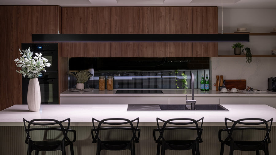 Black Linear Pendant Light Above Modern Kitchen Island