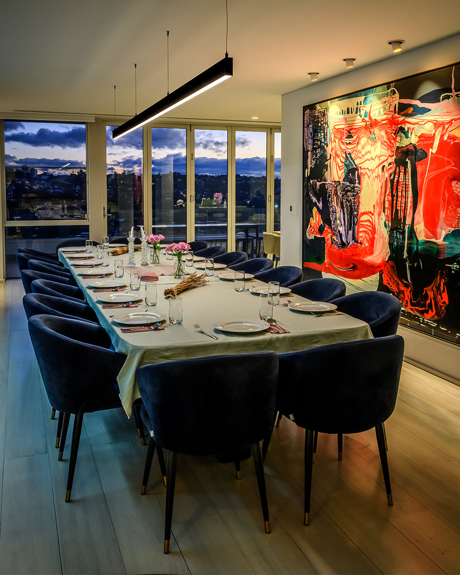 Black Linear Pendant Light Above Dining Table