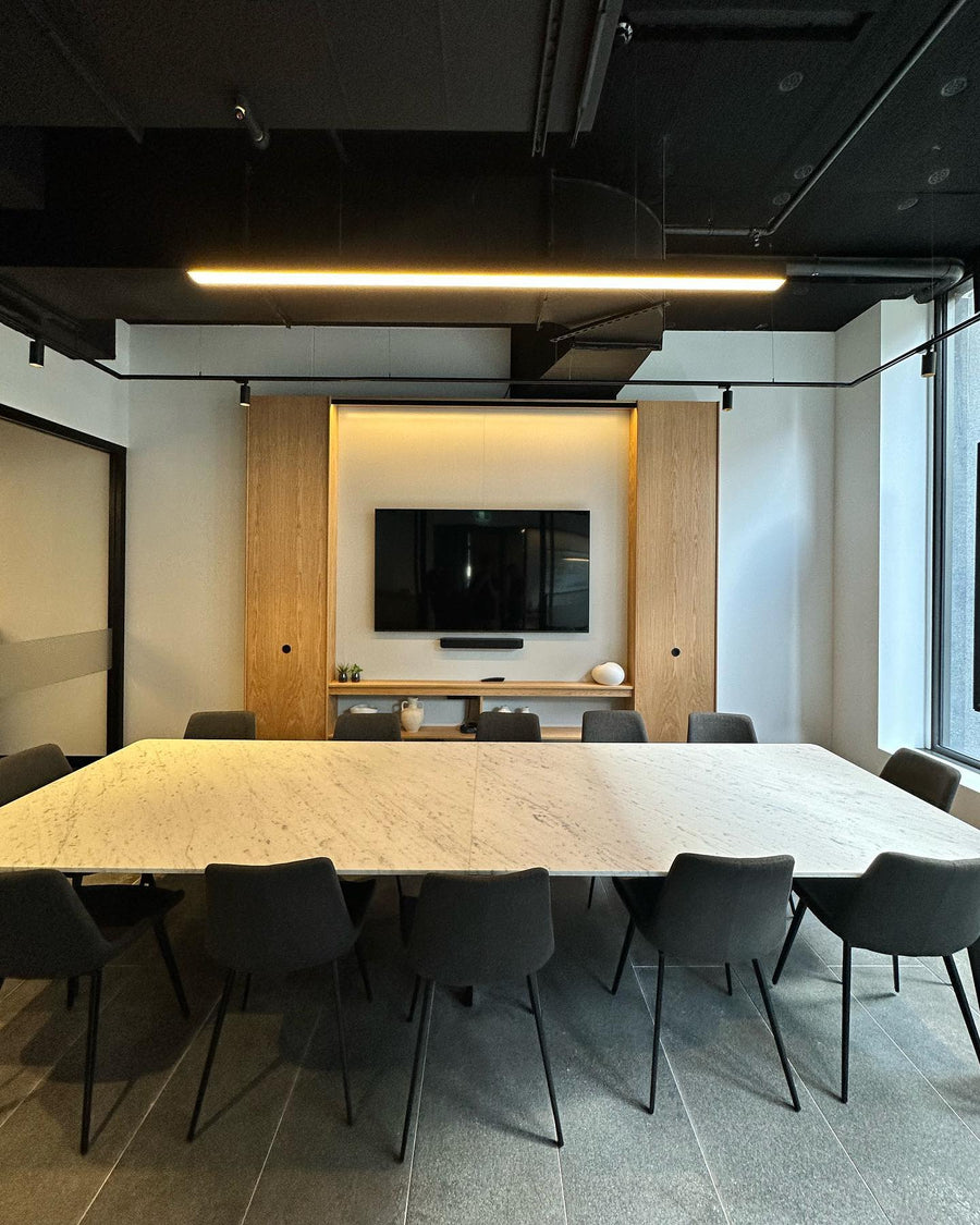 Black Linear Pendant Light Over Office Boardroom Table